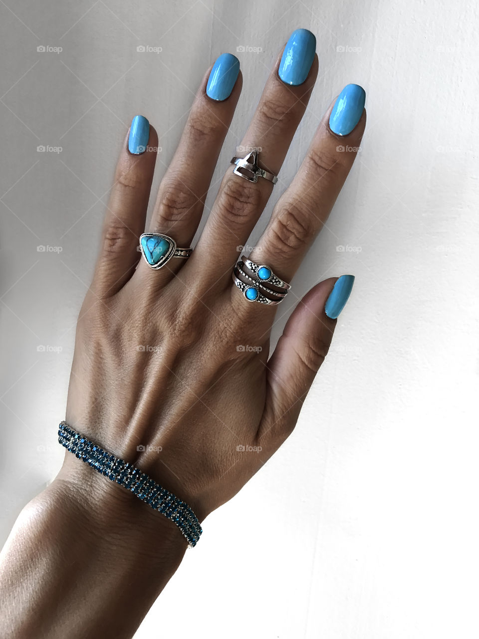 Blue manicure and jewelry 