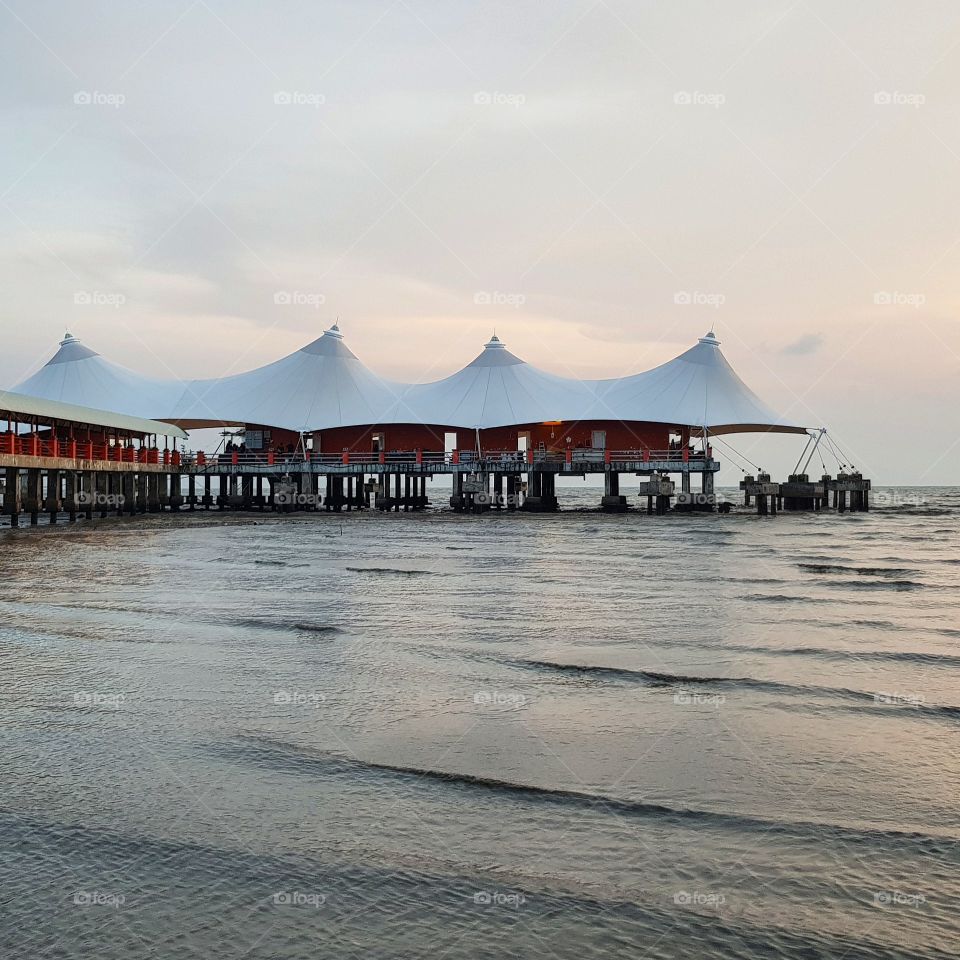 White roof building on sea against sky