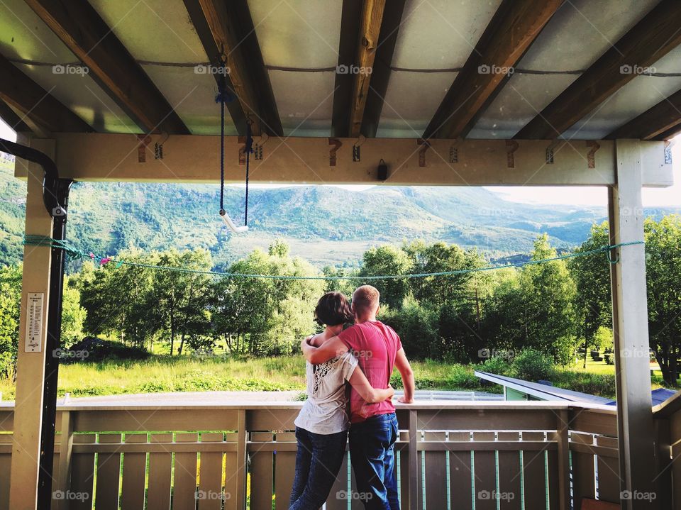 Couple on the balcony enjoying mountains