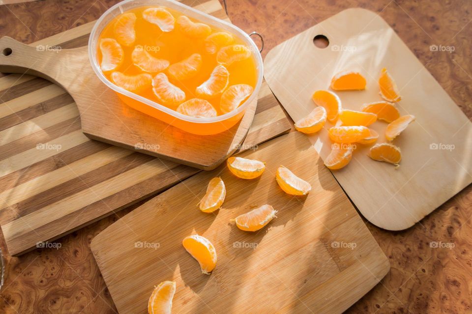 Delicious orange jelly with tangerine slices in a container and jelly worms.