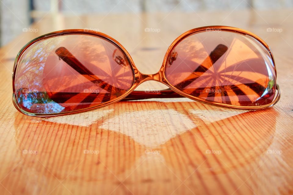Reflection of umbrella on sunglasses