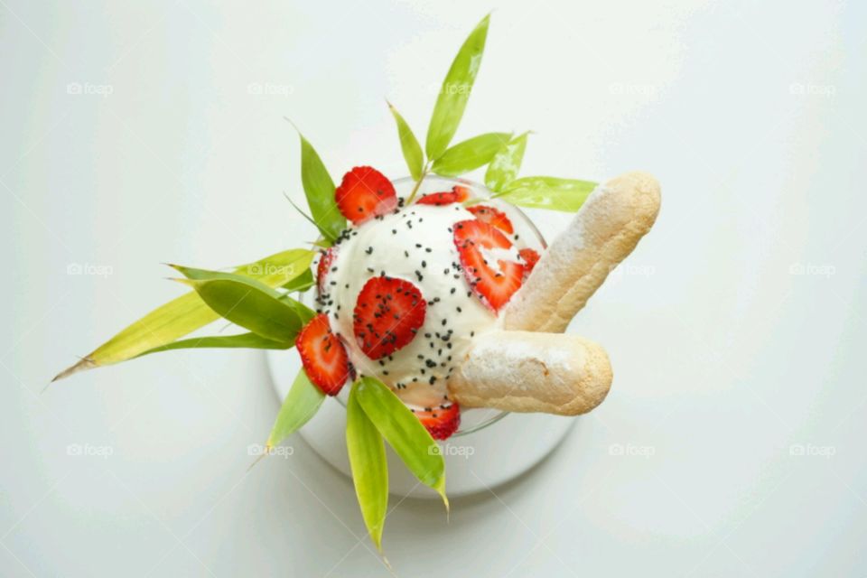 Elevated view of ice cream with strawberry