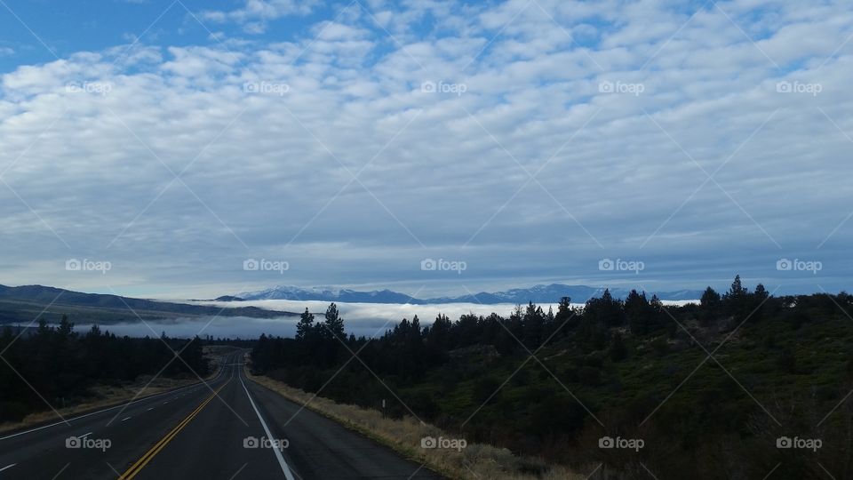 cool clouds rolling off Mount Shasta open roads