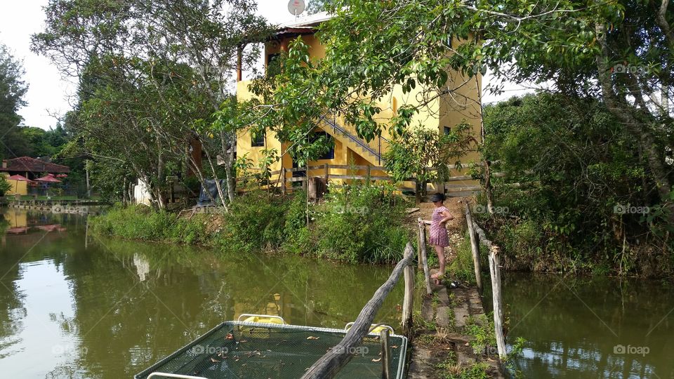 Woman fishing in pond