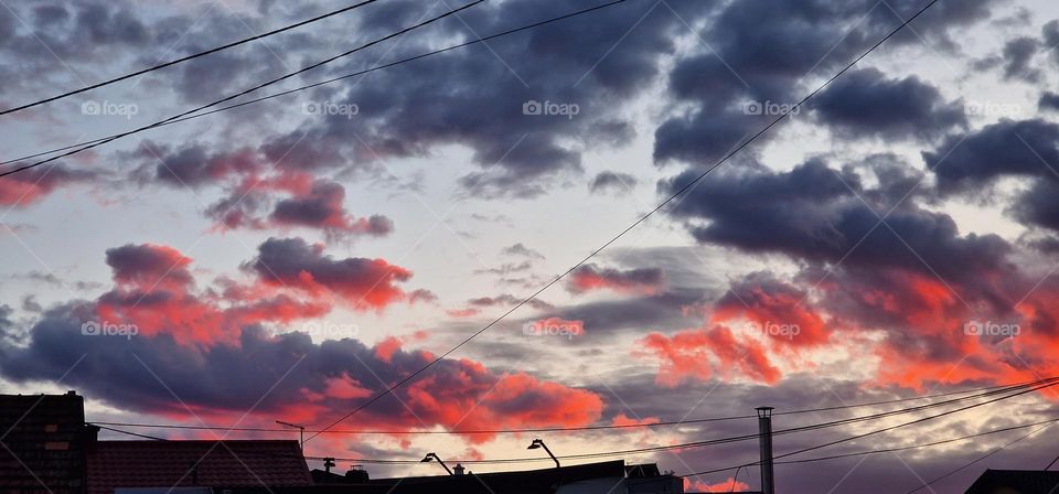 Red clouds over city