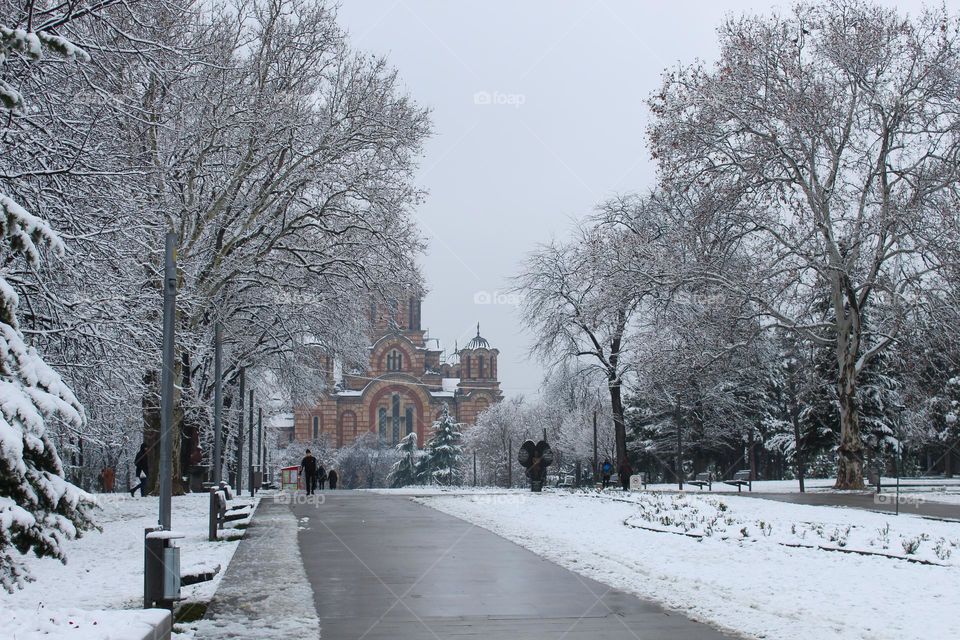 Winter snowy idyll in the city park with the St Mark's Church in the background.  Belgrade,  Serbia