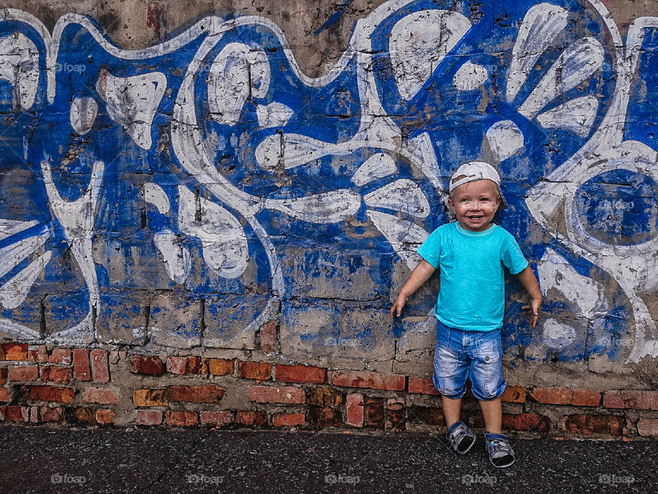a boy with graffiti background
