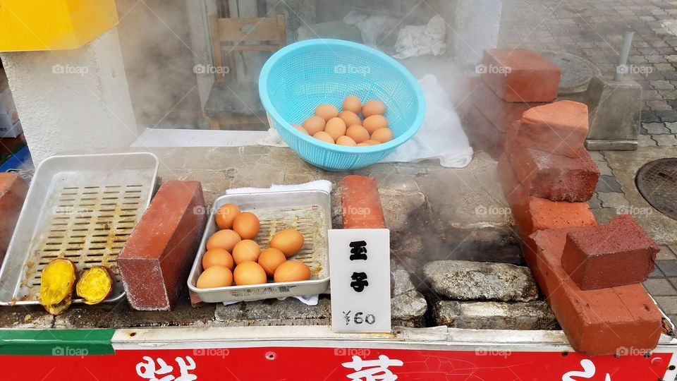 Steaming eggs at hot springs, Japan
