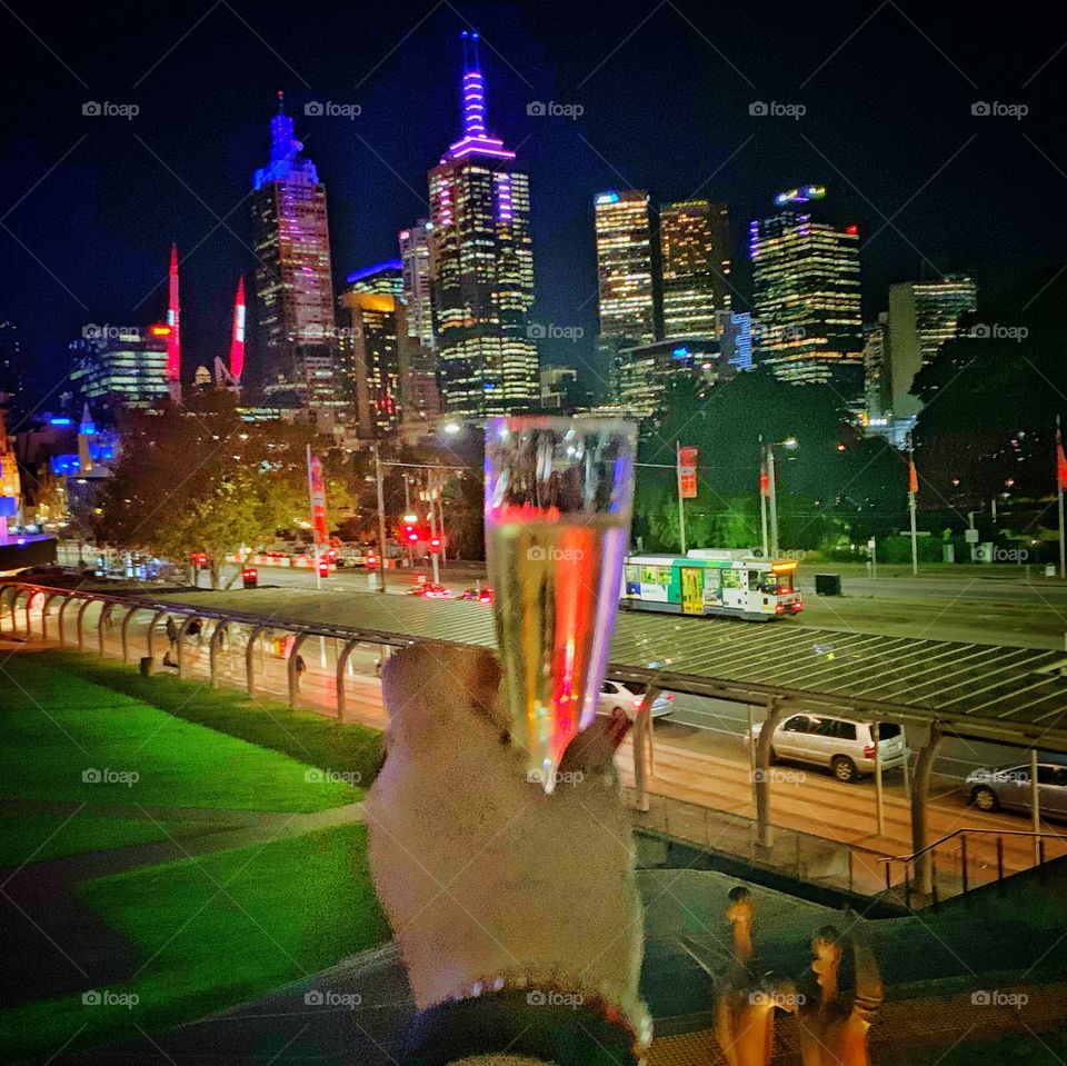 Drinking champagne on the balcony of the Arts Centre overlooking Melbourne skyline / nightlife. A short quiet reflection at the afterparty, after photographing the opening night of a theatre production. 