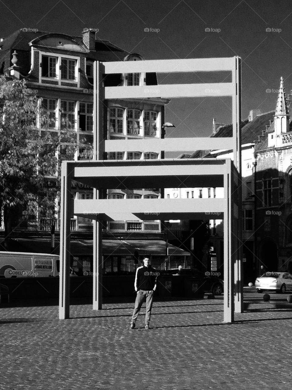 Black and white architecture. Art installation of a big chair on the square