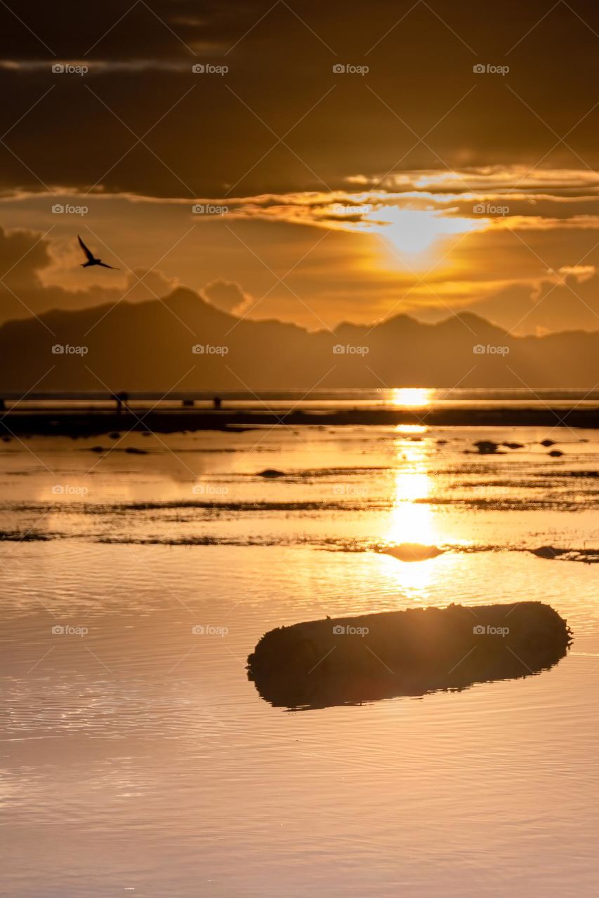 a sunset over the mountains in Palawan Philippines