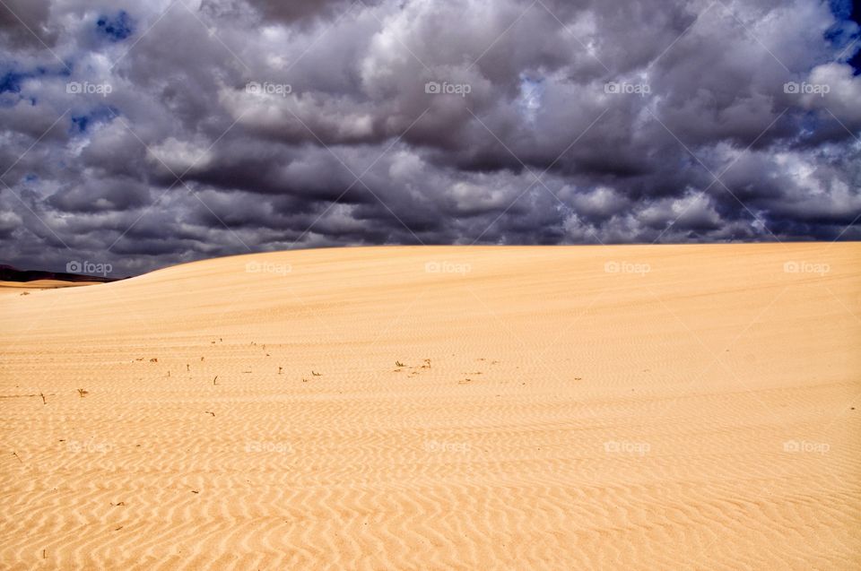 stormy clouds over the sandy dunes of corralejo on fuerteventura canary island in spain