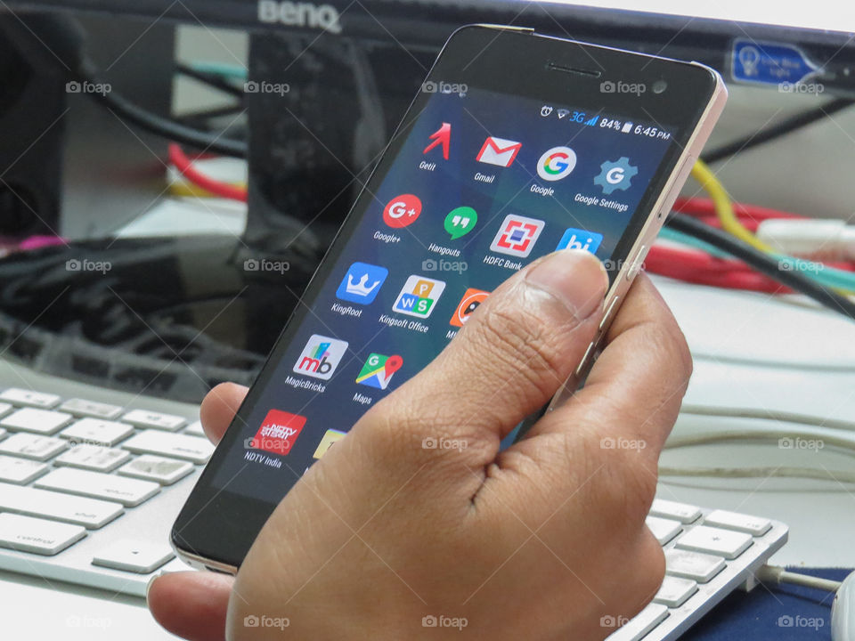 man holding mobile phone at work