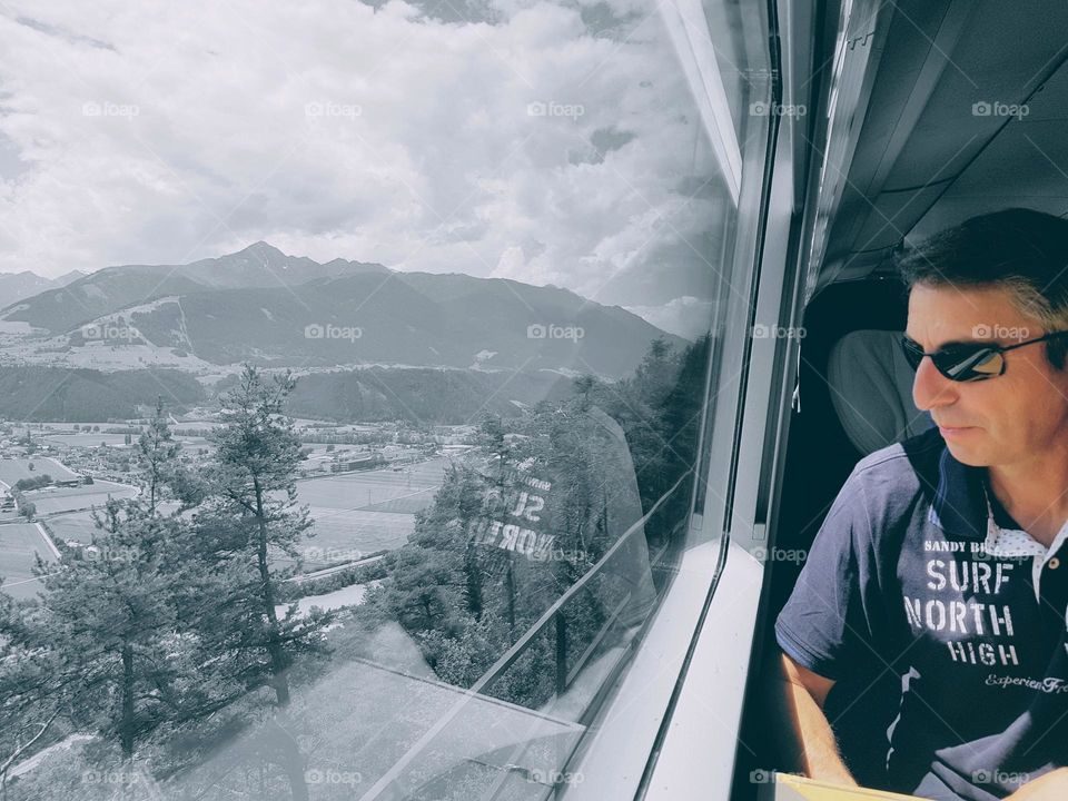 Man in the Train watching landscape , Austria