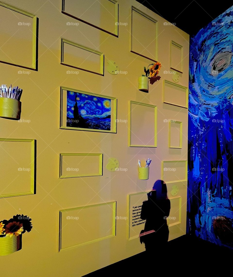 A woman silhouette in a yellow wall