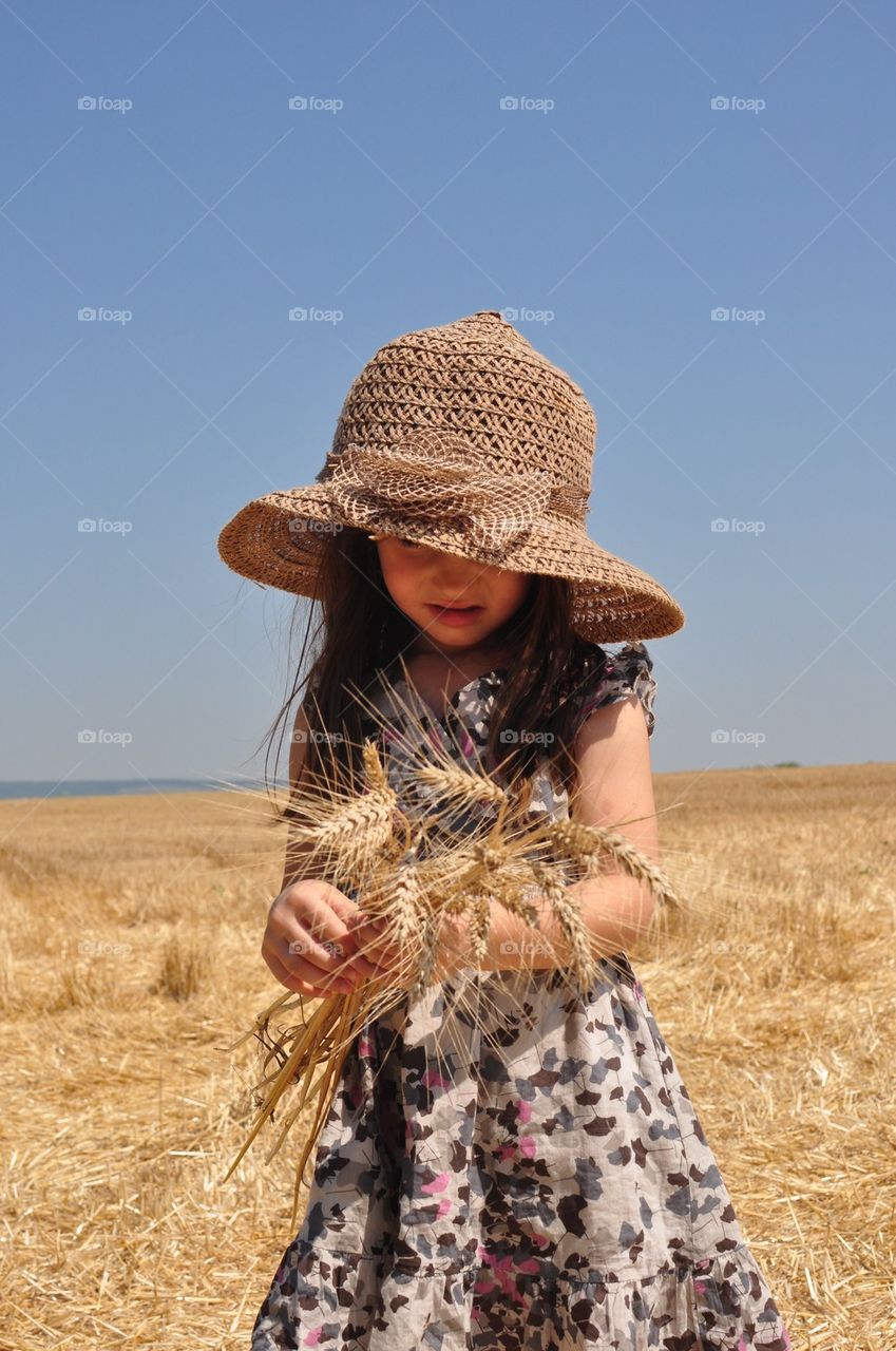 Girl on wheat field 