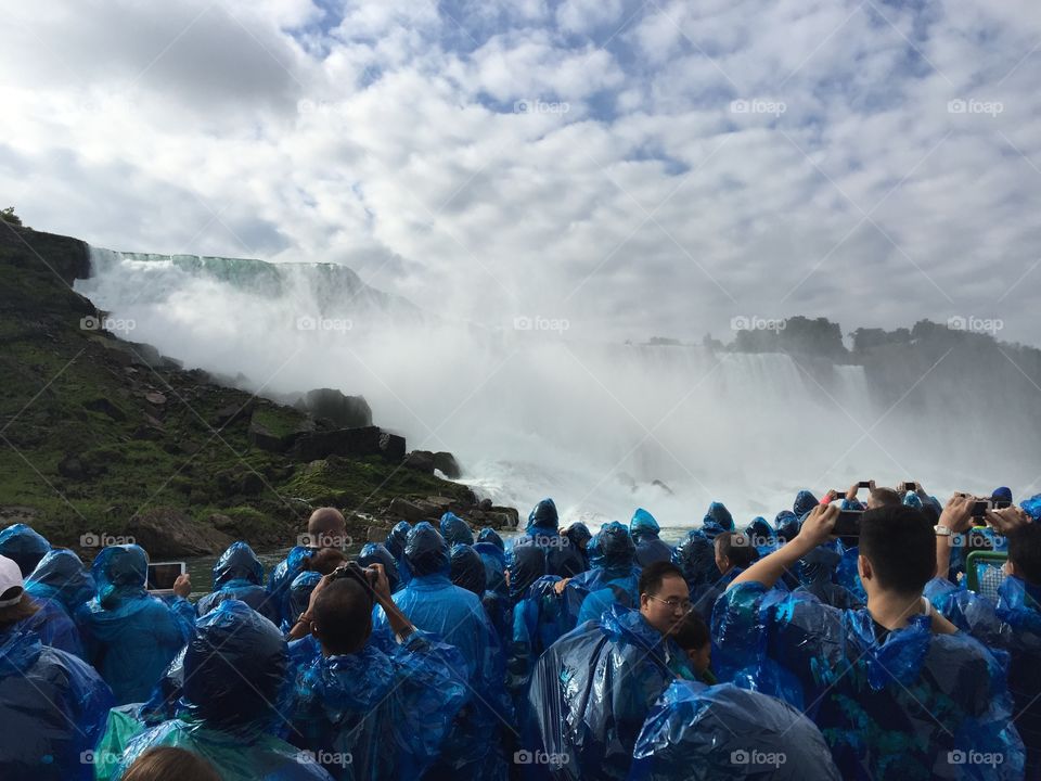 Tourist watching Niagara Fall in rainy weather