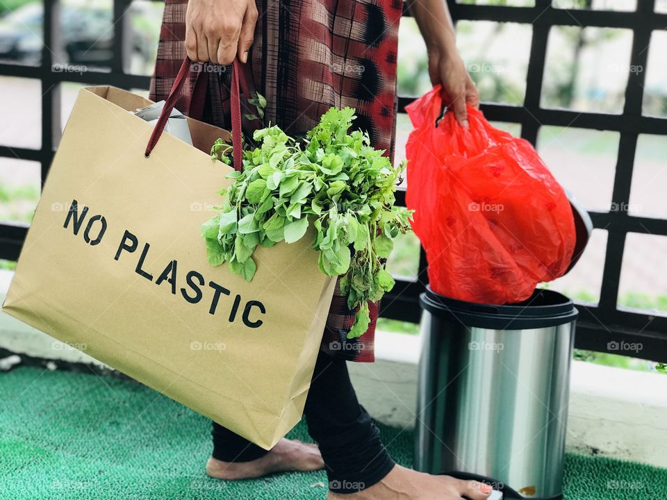 Throwing polythene cover in dustbin and using paper bags instead of polythene covers.