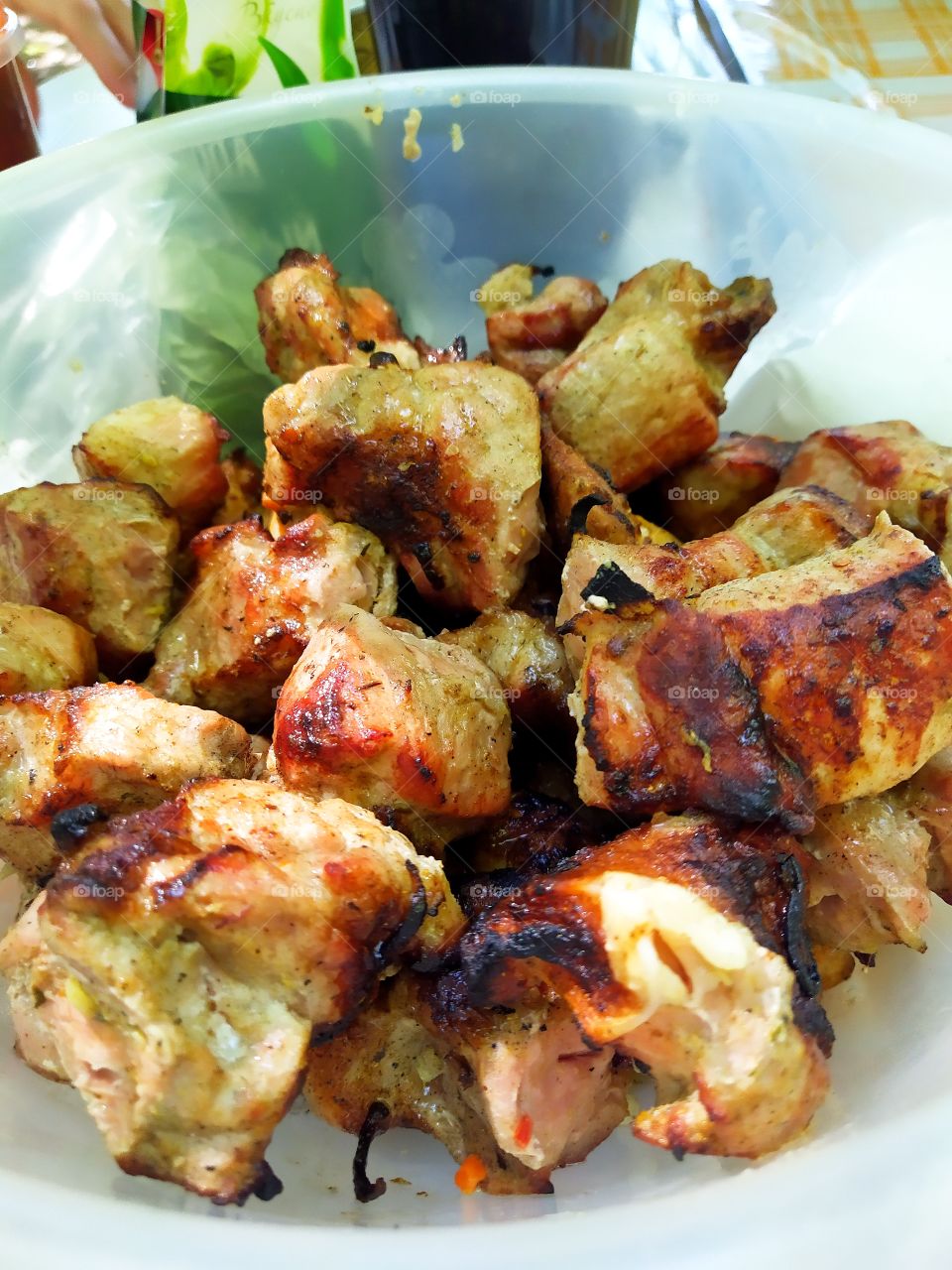 Grilled fried meat in a polymer bowl