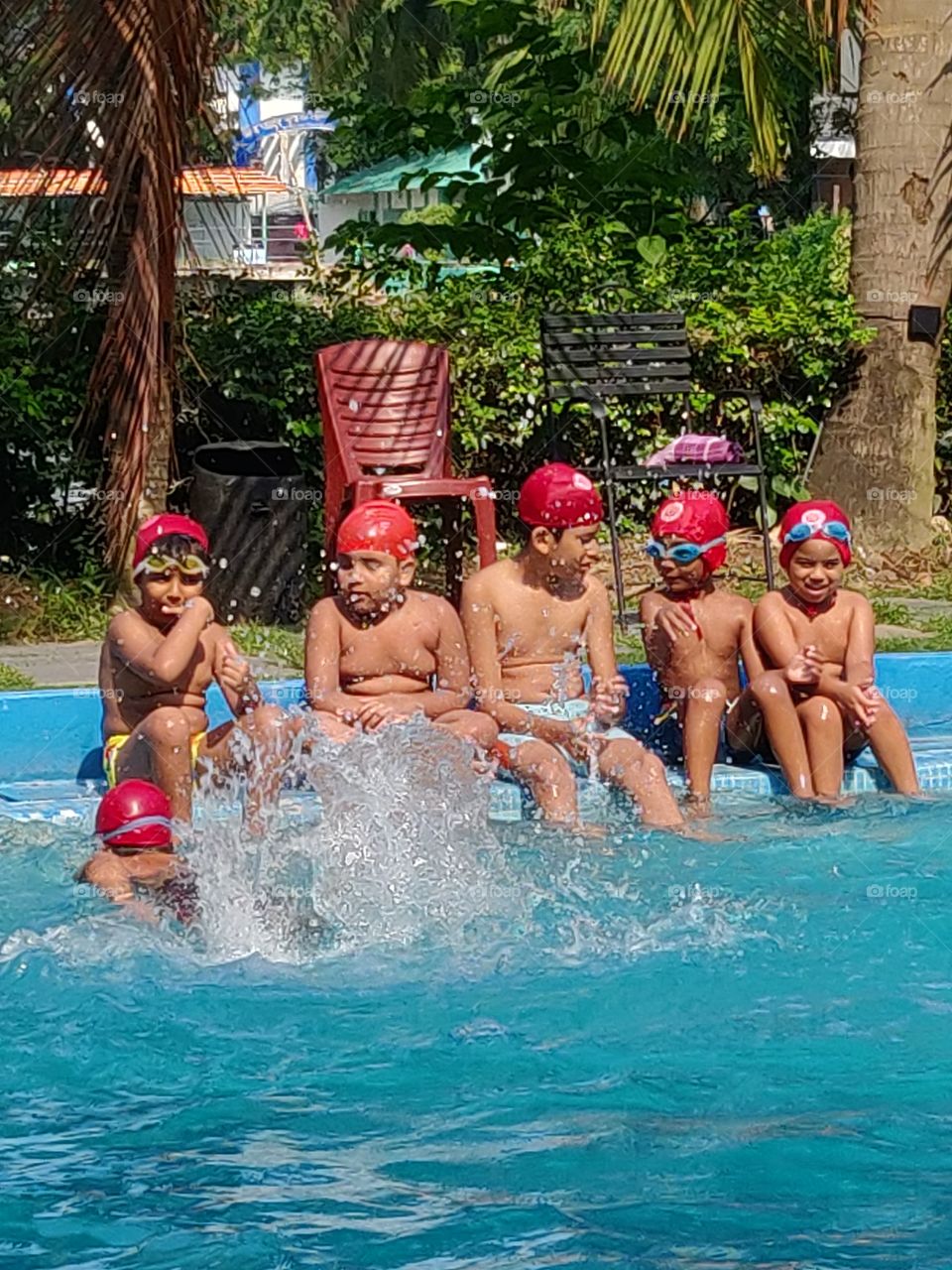 kids or children learning swimming during the long summer vacation