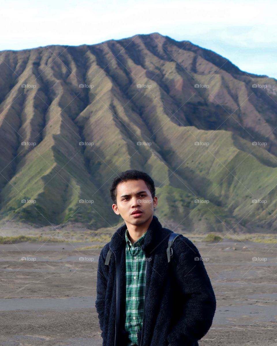 A Man with Candid Style in The Beautiful Landscape Named Bromo During The Day
