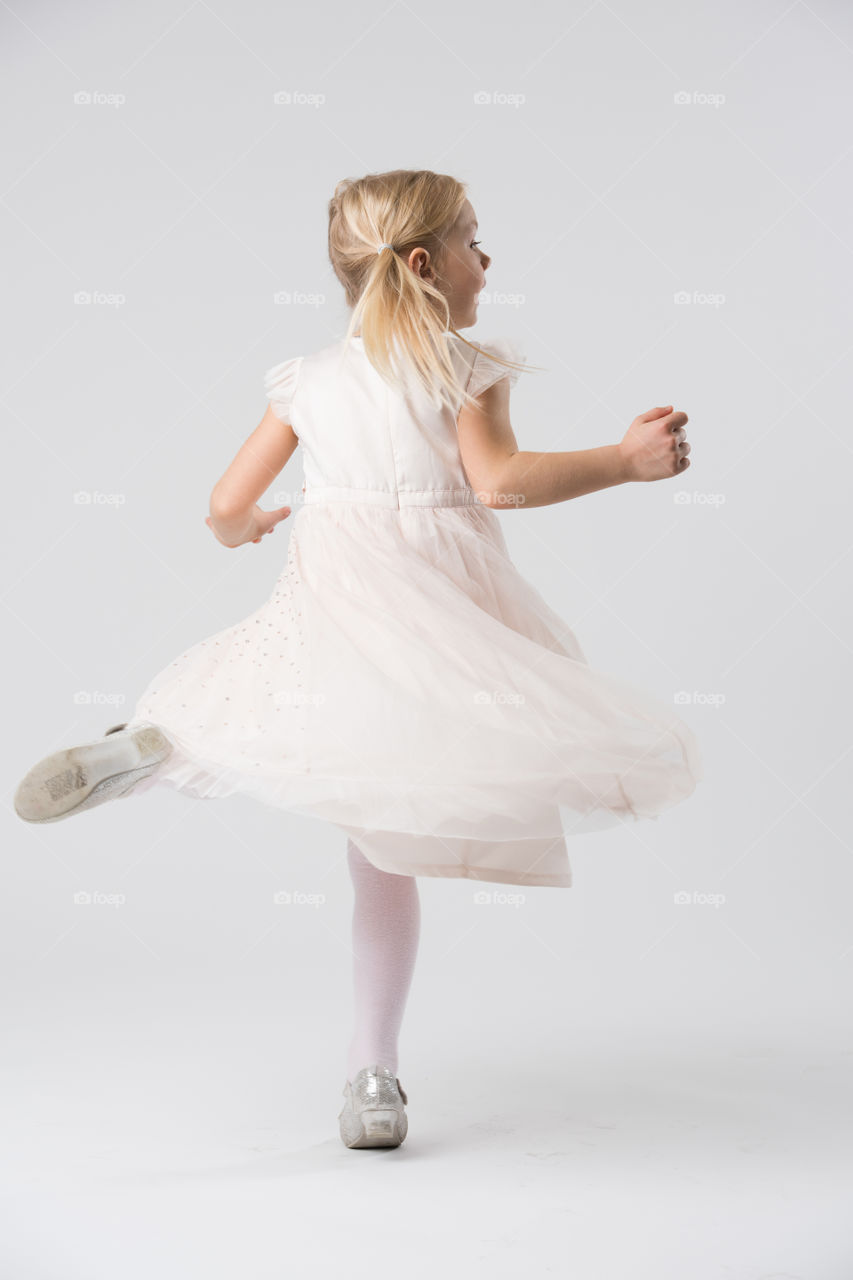 6 year old child model posing in a studio.