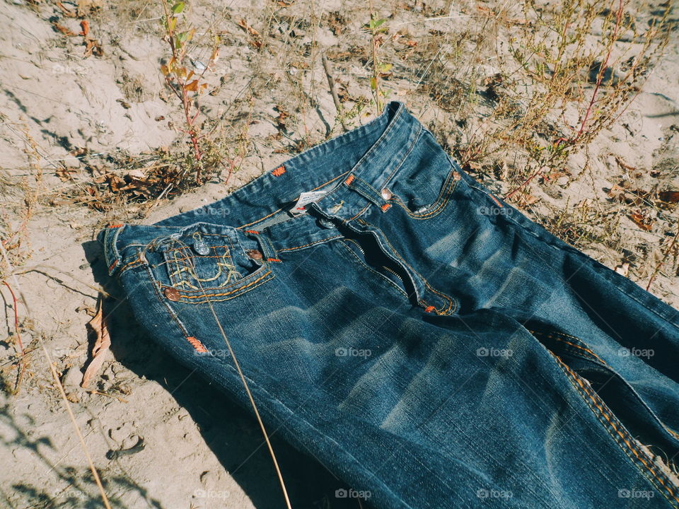 jeans lie on sand