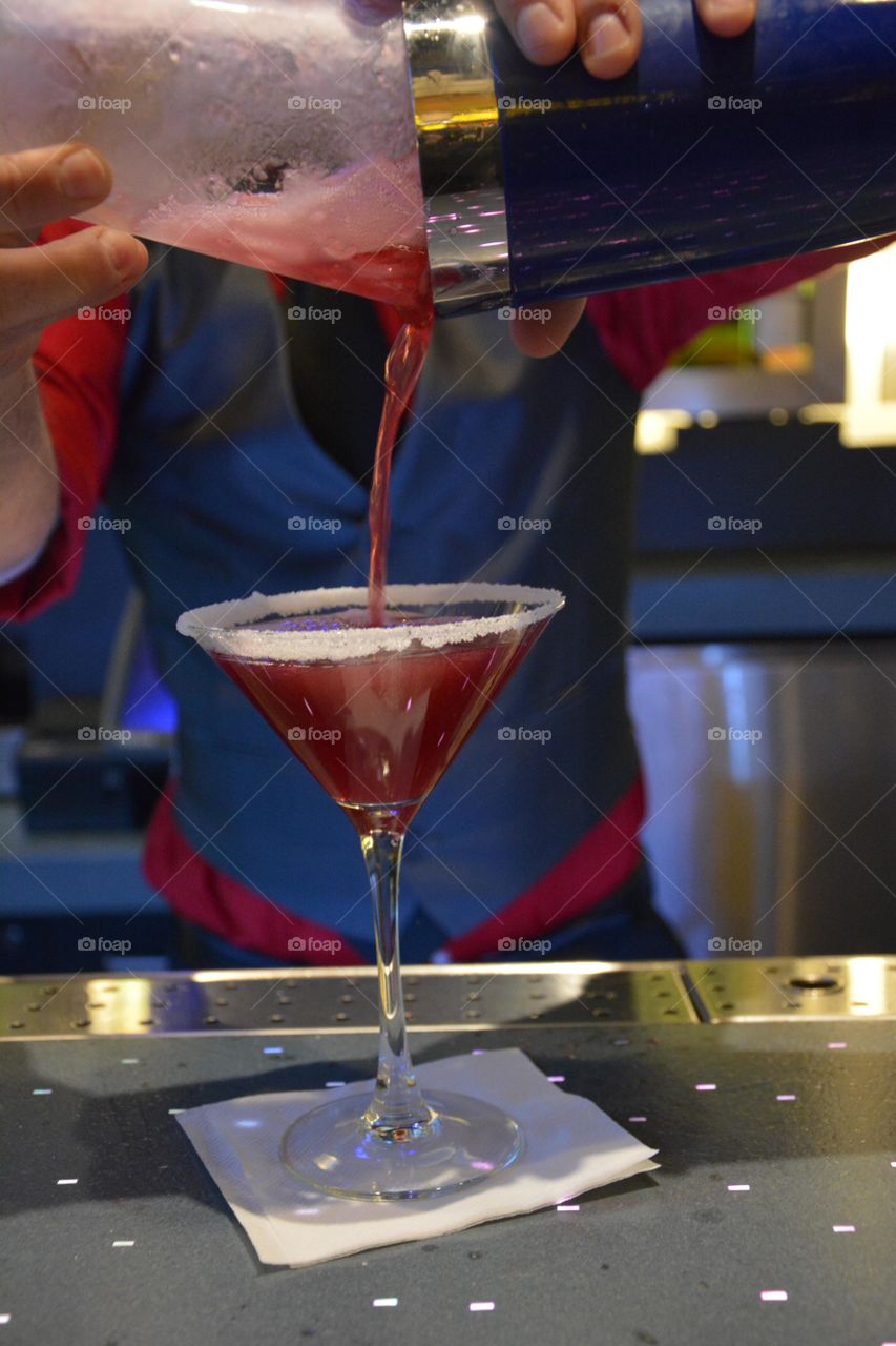 bartender pours a fancy cocktail