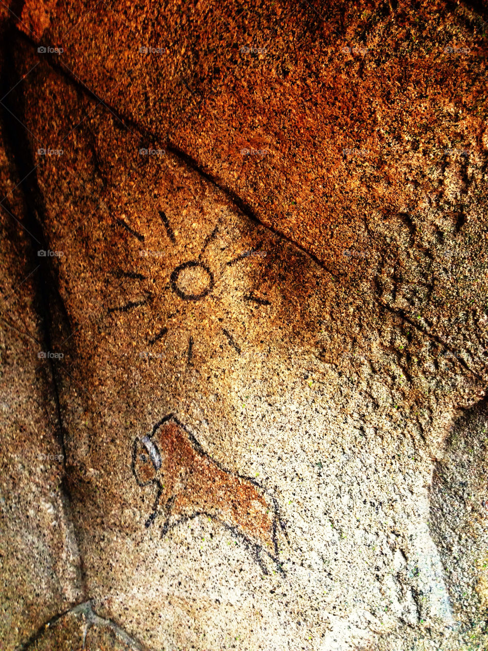 Paleolithic cave paintings on an ancient granite wall