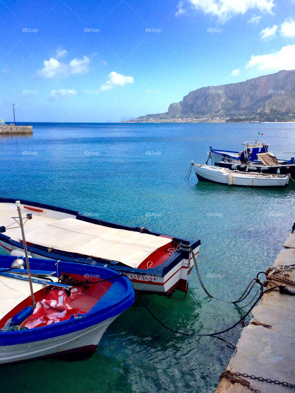 Boats docked in the bright blue Tyrrhenian Sea 
