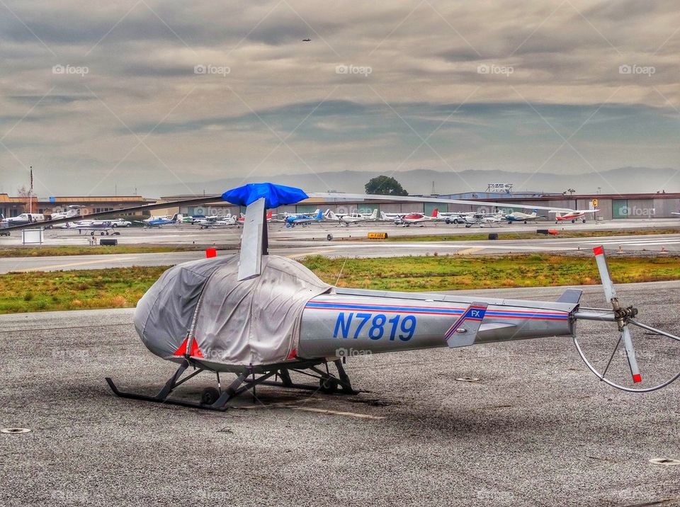 Helicopter On Airport Tarmac. Enstrom Helicopter Awaiting Flight
