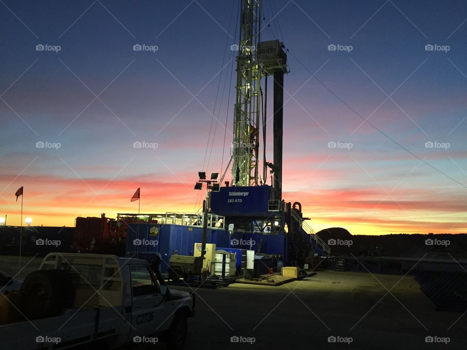 Sunset behind drill rig