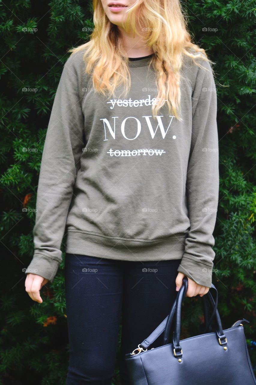 Girl wearing a sweater with text