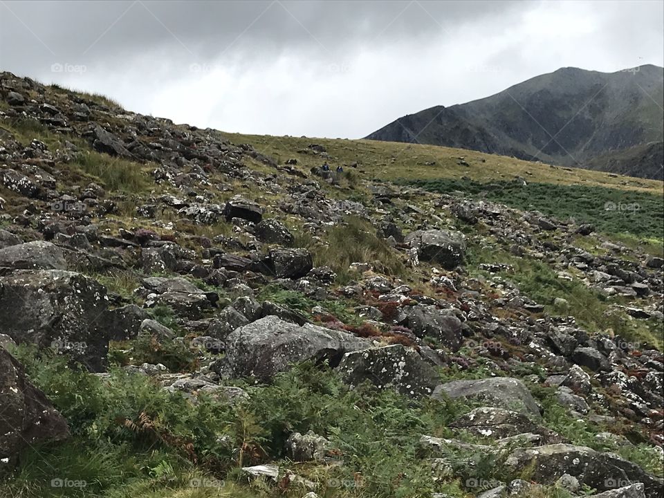 Overcast over green, rocky terrain in Wales