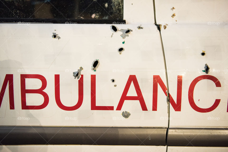 A real ambulance from the Red Cross who had been attacked in war. The Ambulance has bulletholes just everywhere and even firebombs have been thrown against it. The ambulance is part of efforts to make people aware of what happens in war. Ambulance shown up in various parts of the world. The picture is from Malmö Sweden.