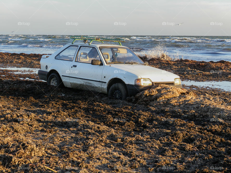 the car stuck on the seashore