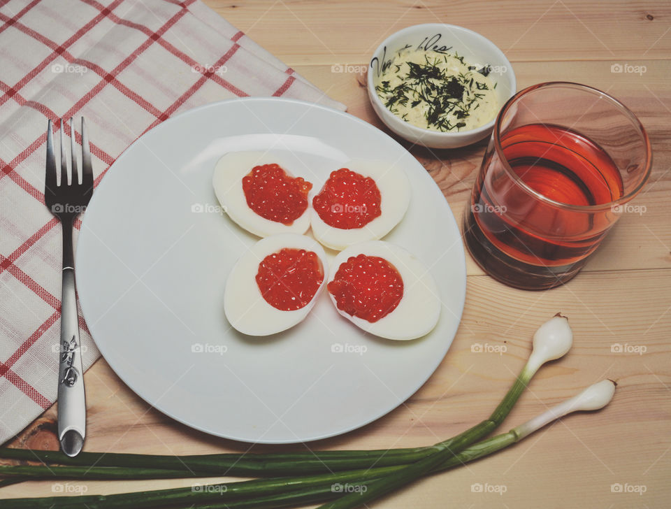 Red caviar with egg on a plate. Red caviar with egg on a plate.
