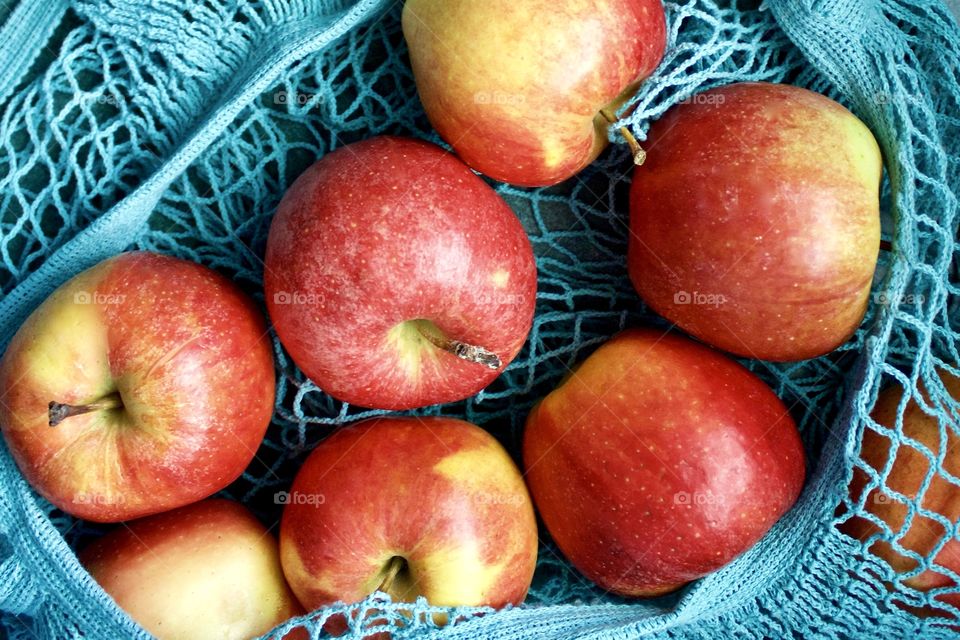 Fruits! - Apples in a light teal-colored string produce bag