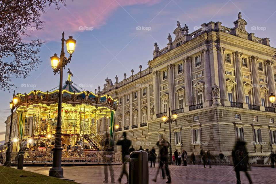 Illuminated carousel in front of Royal Palace in Madrid, Spain