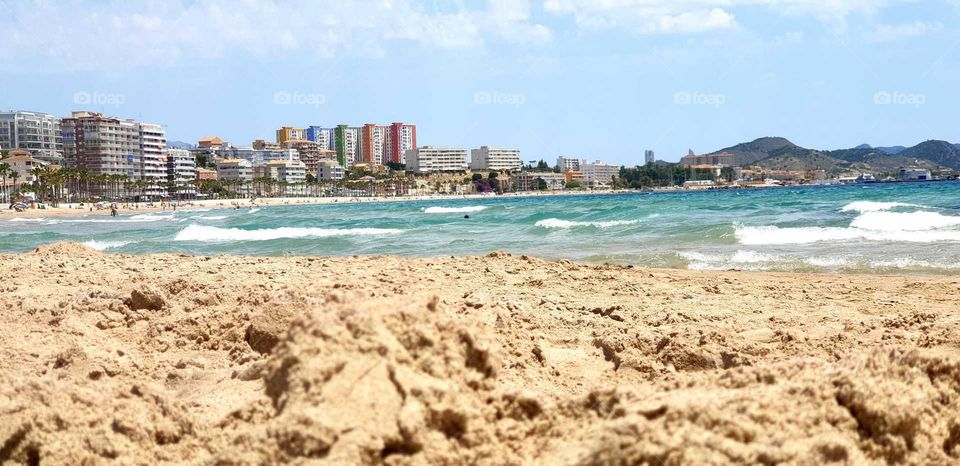 Beach#sea#sand#waves#town#sky