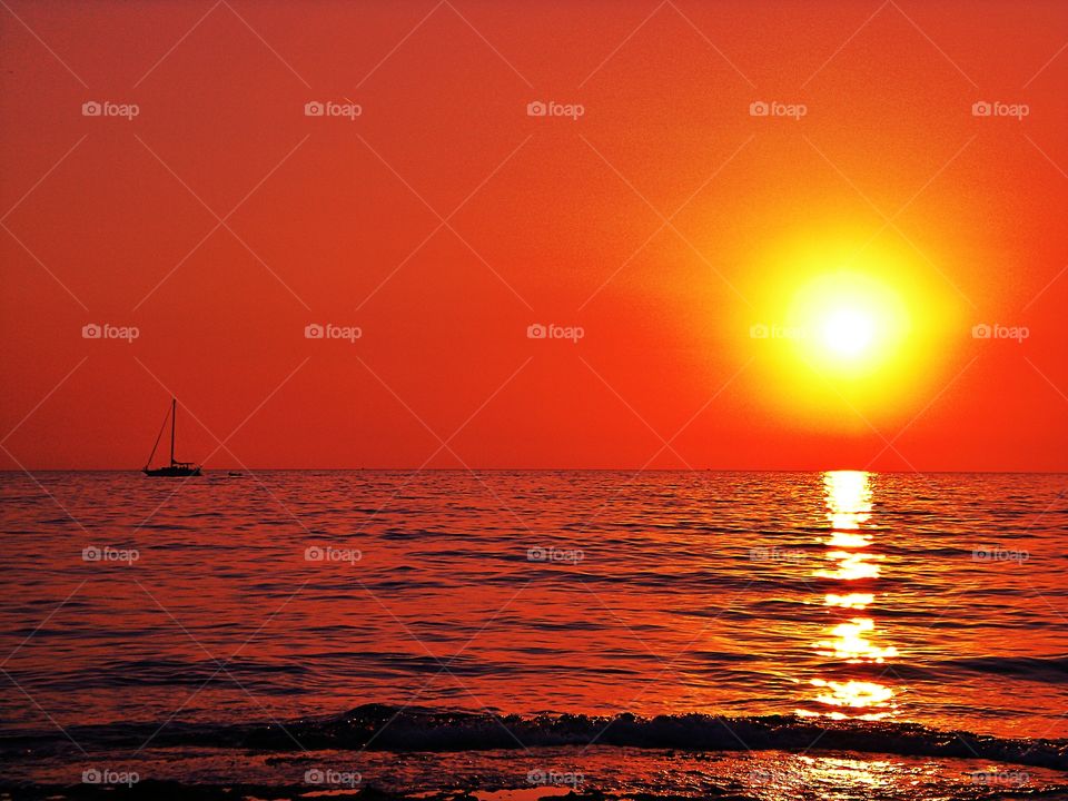 Sailboat in the sea at the Sunset over Palinuro ( Italy ).