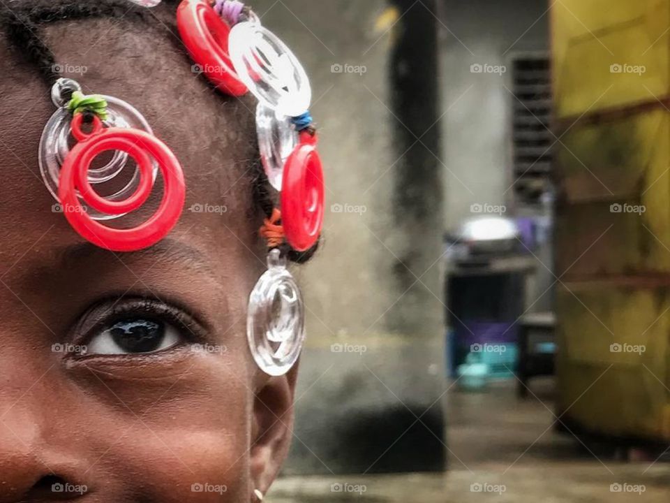 Little girl walking in Abidjan streets.
Africa.