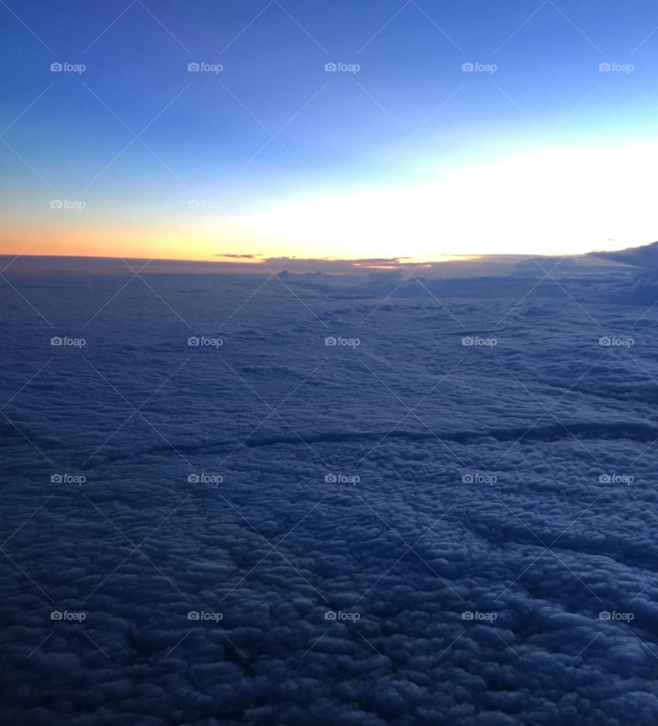 Sunrise over the clouds from the airplane window 