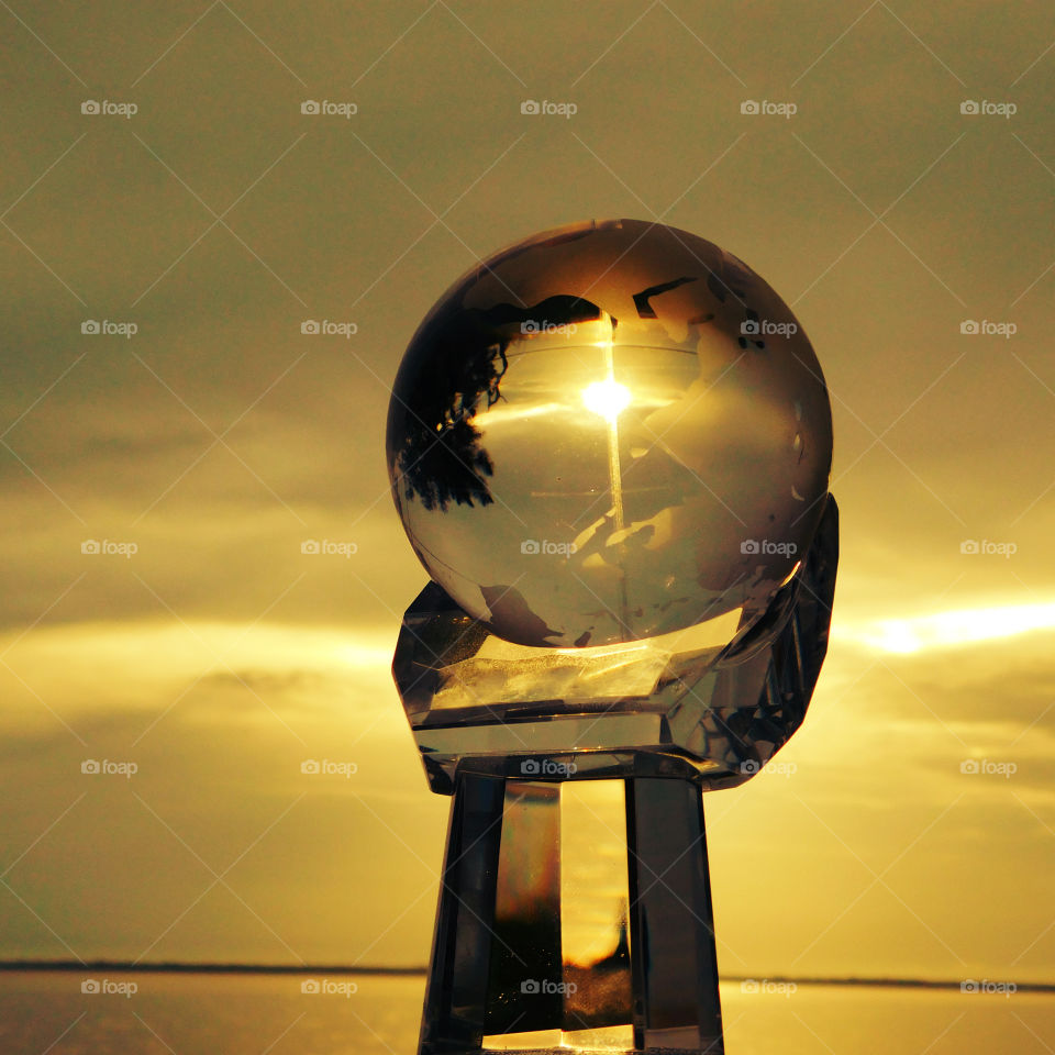 Magnificent sunset through the glass ball 