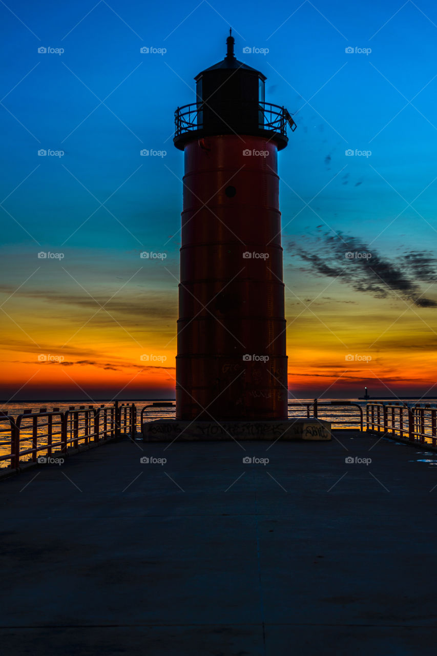 Red lighthouse at sunrise on Lake Michigan in Milwaukee, Wisconsin 