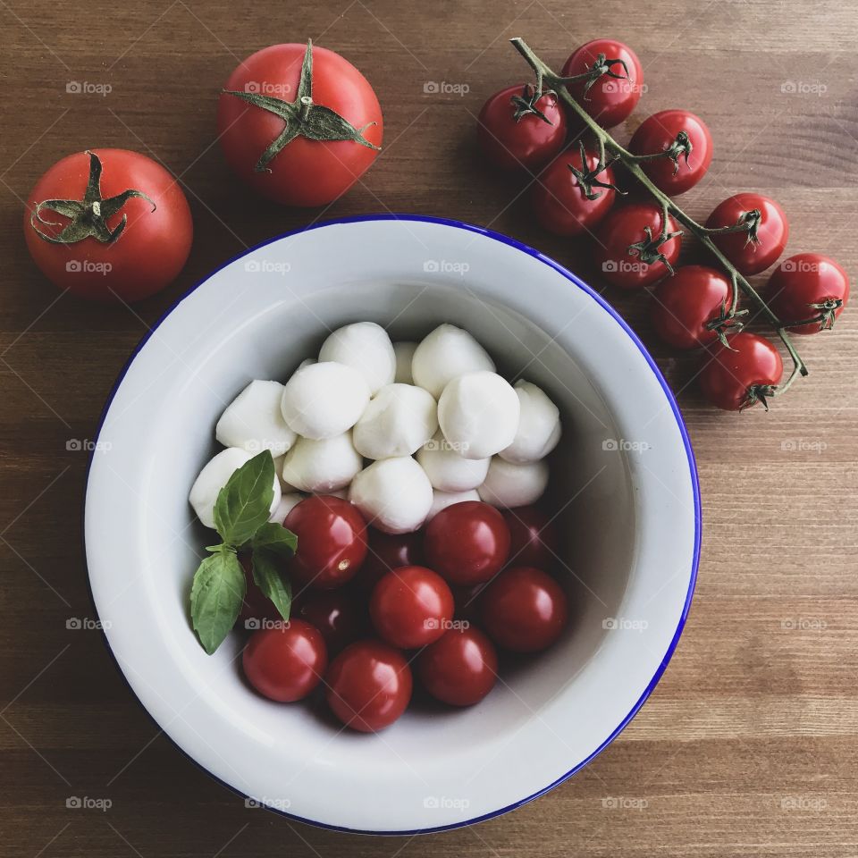 Mozzarella, Cherry Tomatoes and Fresh Basil - Ingredients for Caprese Salad on Wooden Background 

