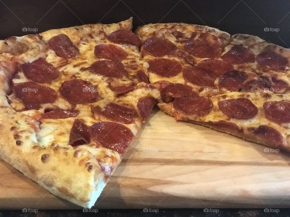 Pepperoni pizza sliced and ready to be served 