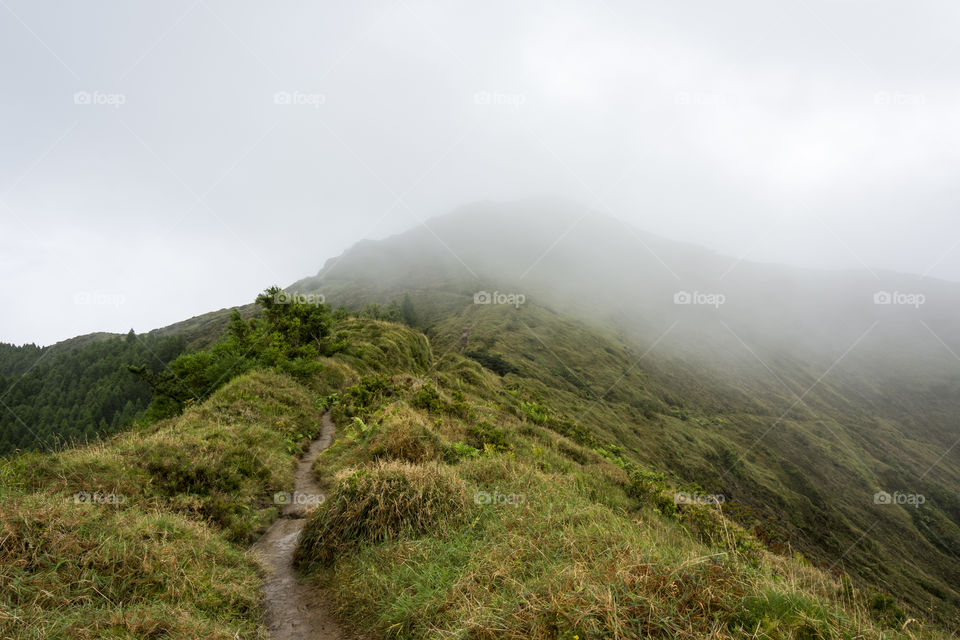 Hiking on Pico da Vara the highest mountain of Sao Miguel island, Azores, Portugal. A cloudy day.