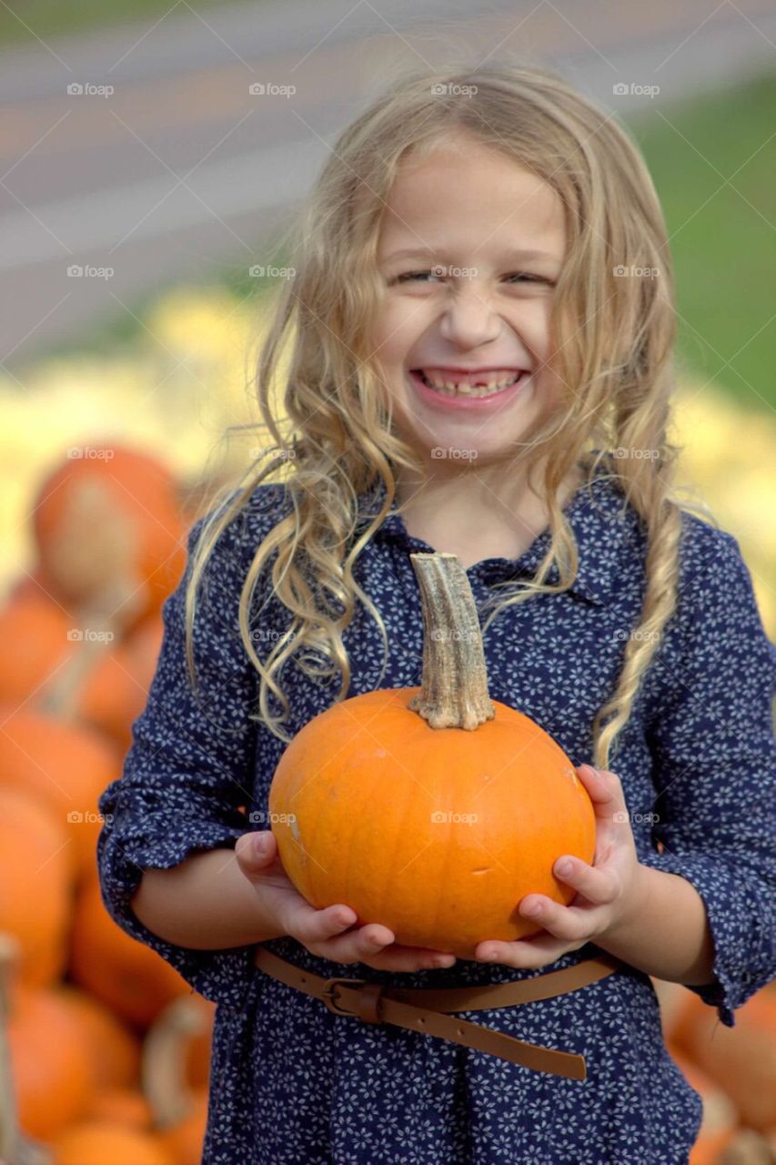 Close-up of a girl holding pumpkin
