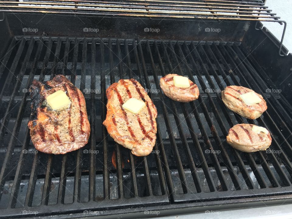 Steaks on a grill in the summer